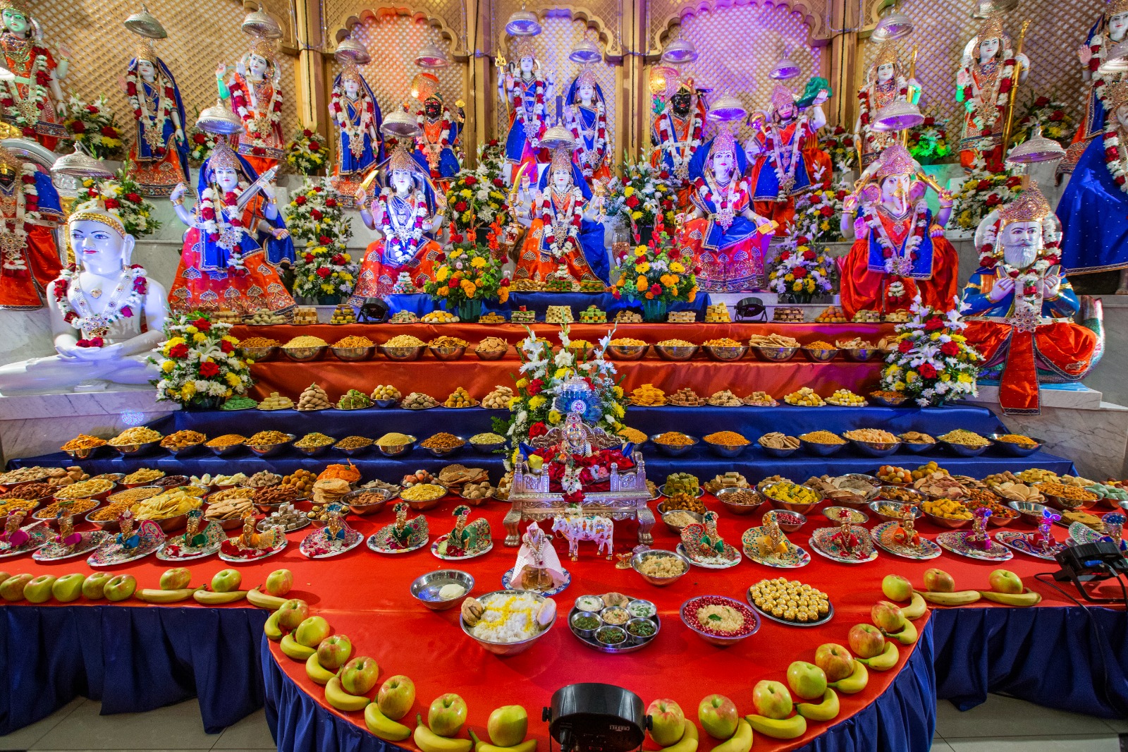 Grand Annakut offering with hundreds of prasadam dishes before the temple deities